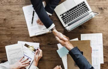 Business people shaking hands together